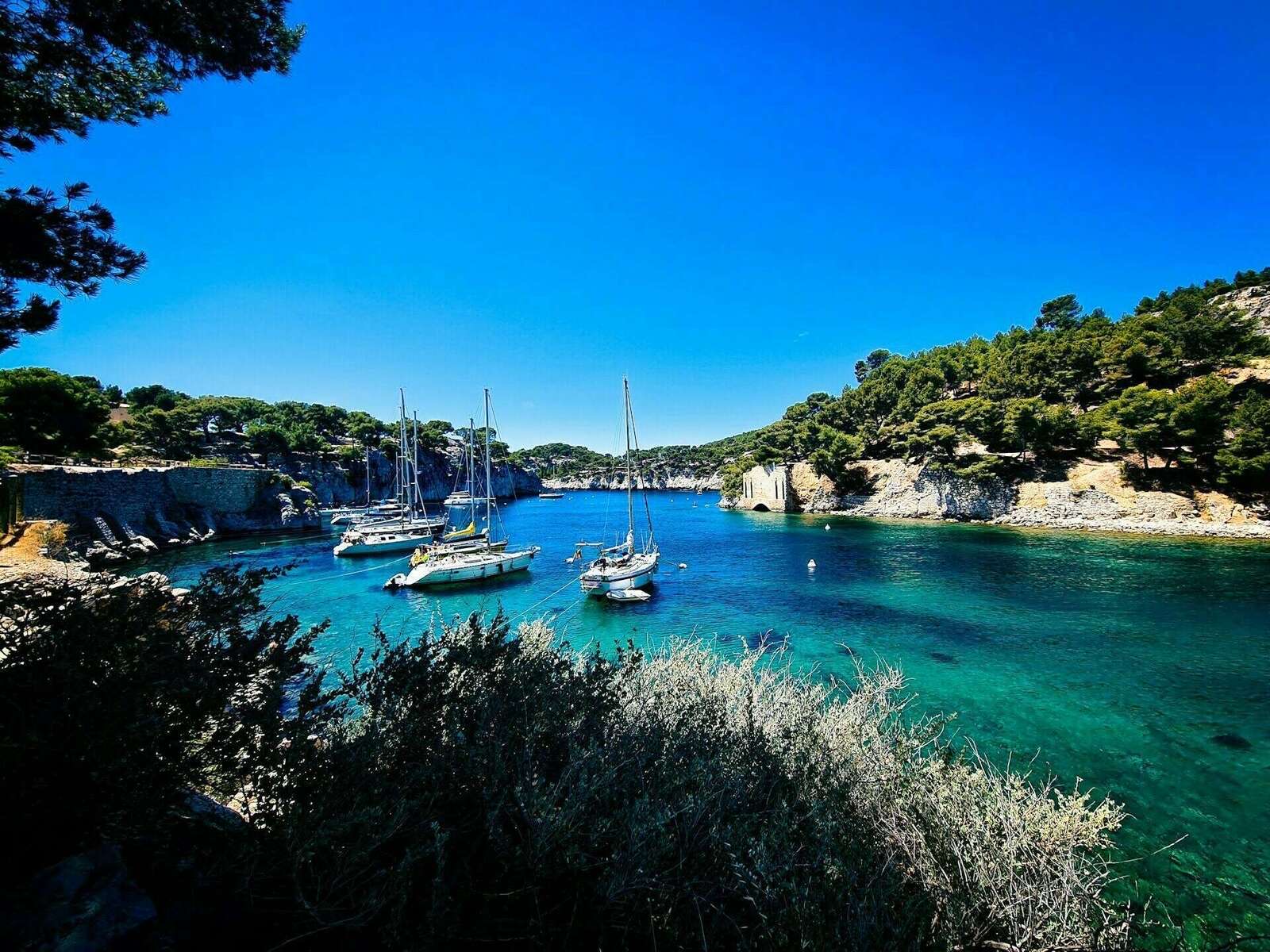 Voiliers dans une calanque aux eaux turquoise